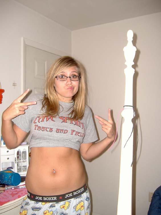 Cute girl in glasses posing nude in her bedroom - 1