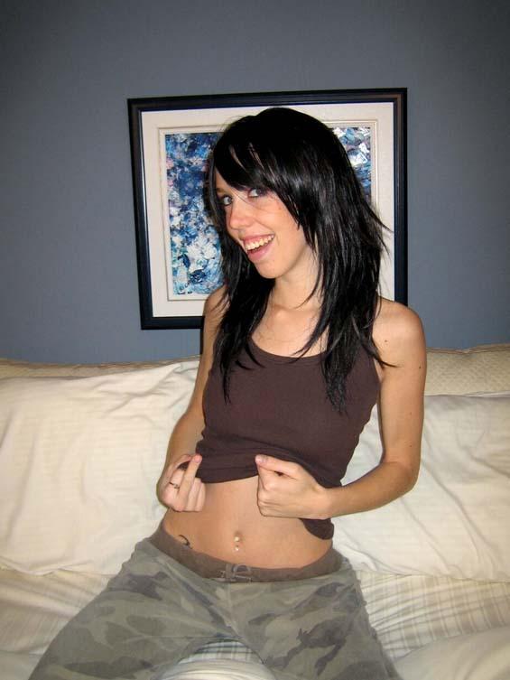 Smiling amateur stripping in bed - 1