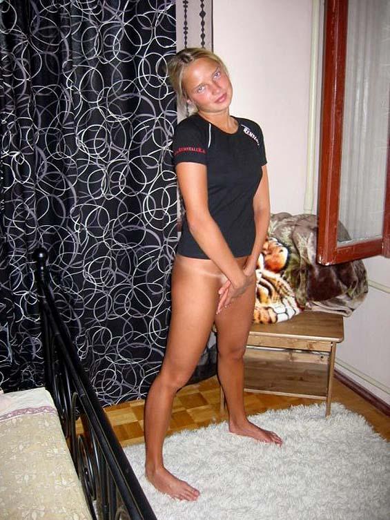 Young blonde shows her tan naked body - 1