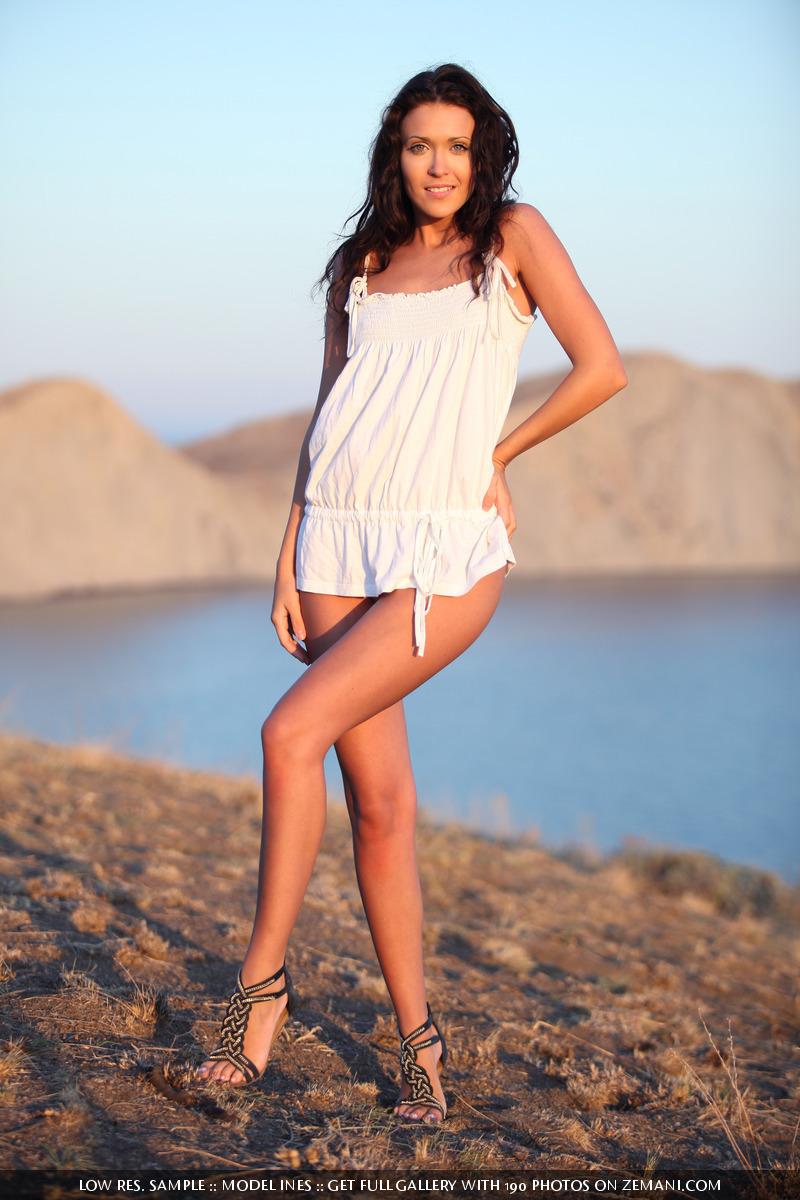 At the sunset, a beautiful brunette removes her white dress - Ines - 1