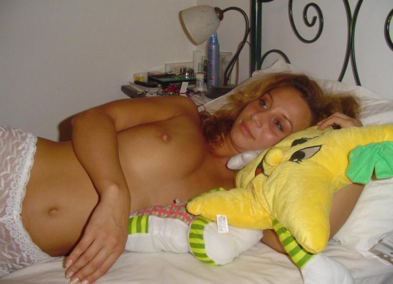 Blonde with curly hair is lying on bed - 3