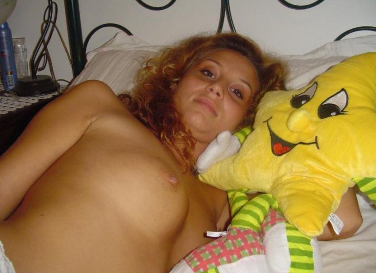 Blonde with curly hair is lying on bed - 4
