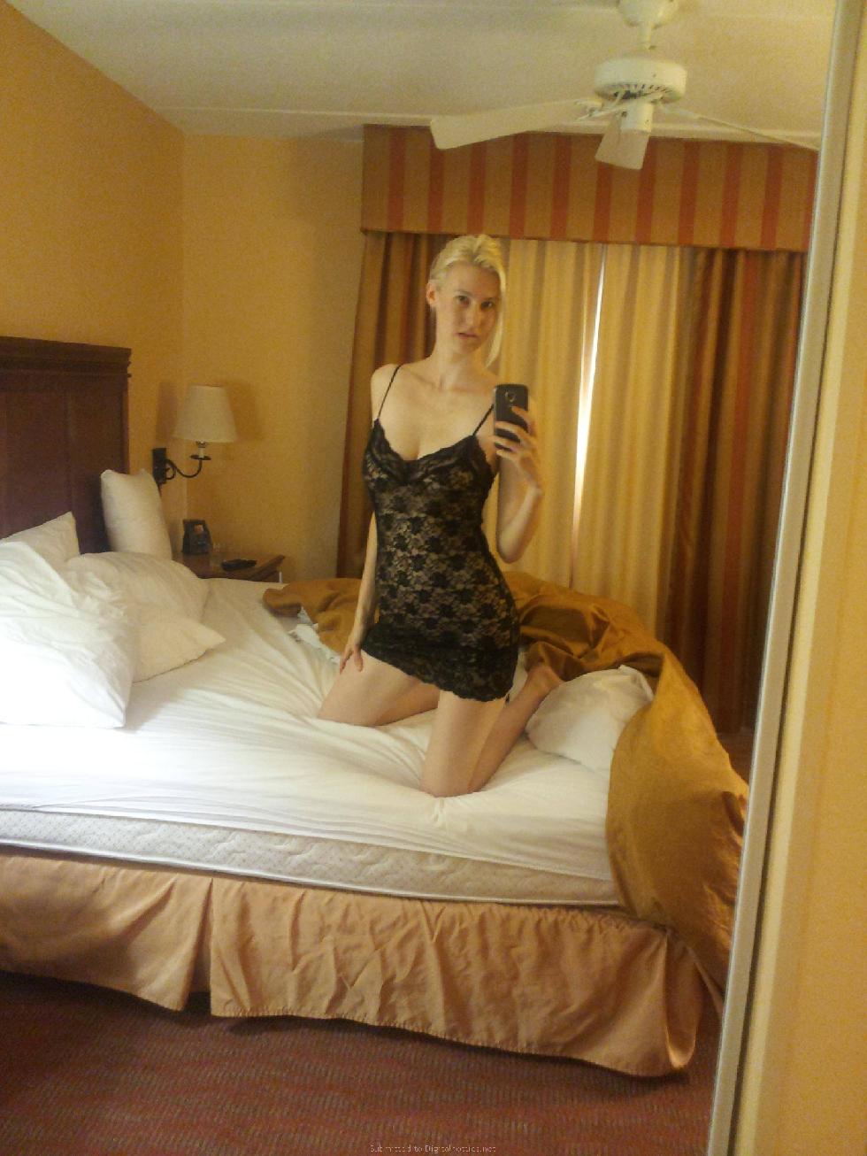 Sexy blonde girl is posing in a hotel room - 1