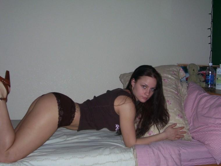 Long-haired brunette is posing on her bed  - 5