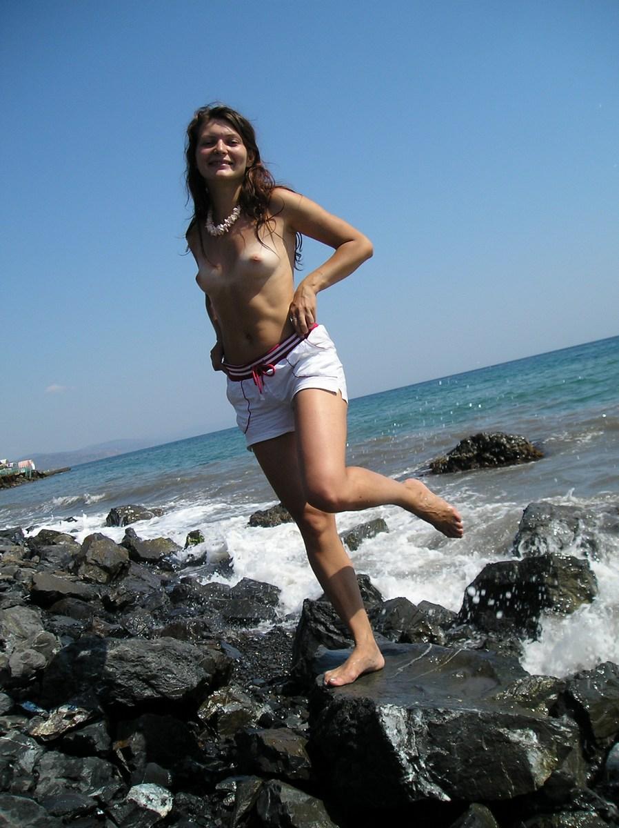 Larisa is posing naked on a rocky beach - 3