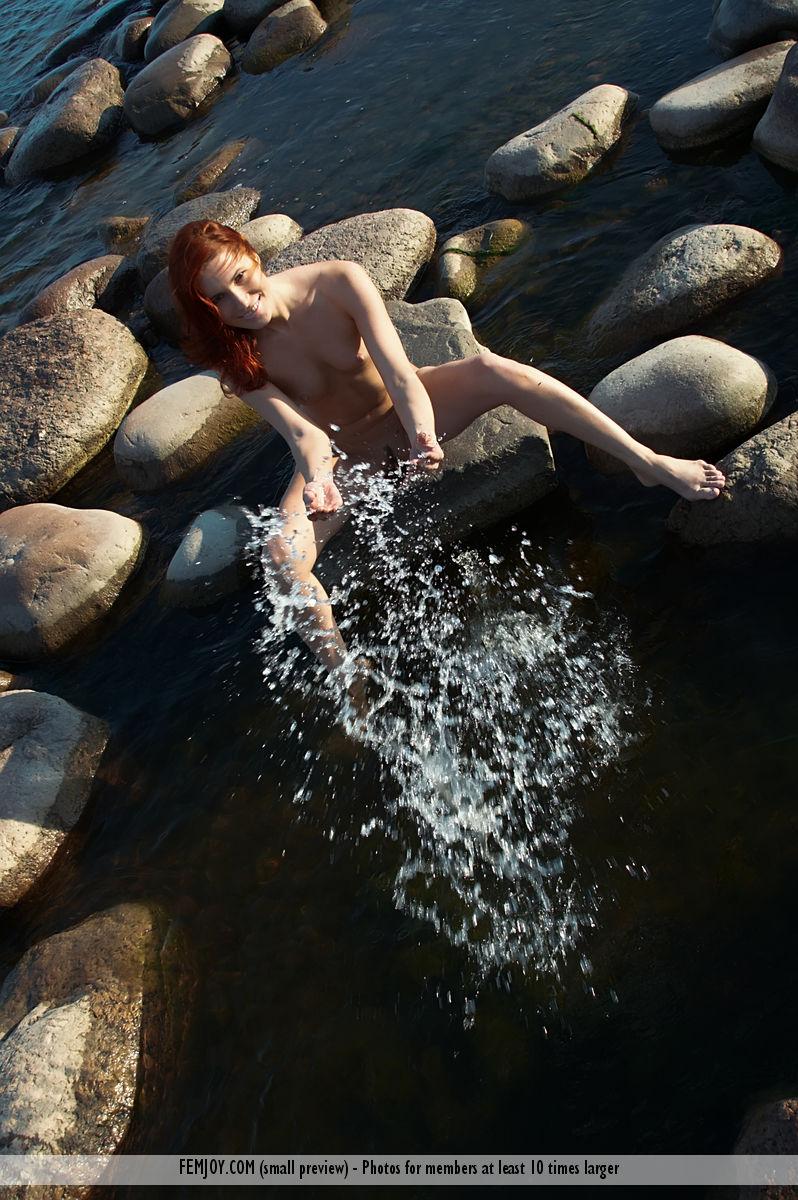 Naked redhead is posing on the rocks - Leila - 16