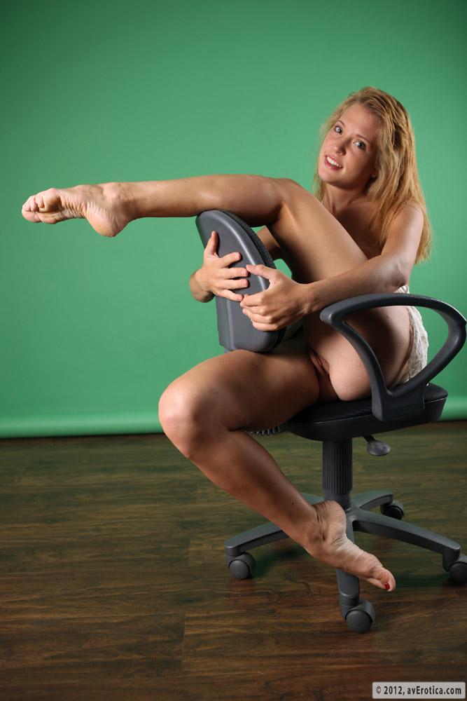 Young Amber is posing on the office chair - 17